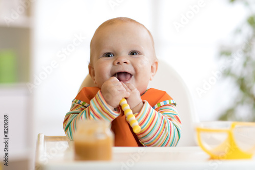 Happy infant baby boy spoon...