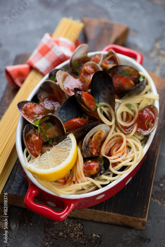 Spaghetti with vongole clams and mussels served in a bowl, selective focus