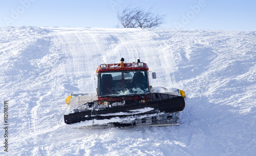 Tractor on the ski track in winter