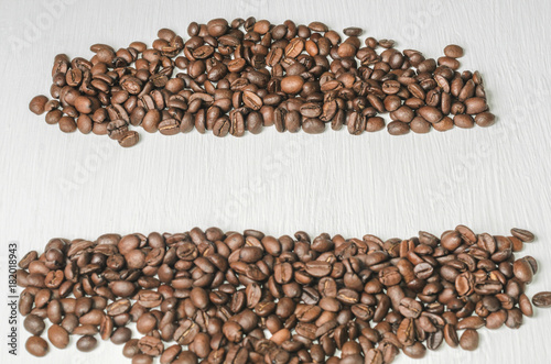 Frame of coffee beans with free space for text, white background top view © Maksim