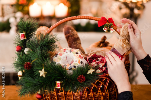 Photography Woman hand arranging Christmas goods in a basket