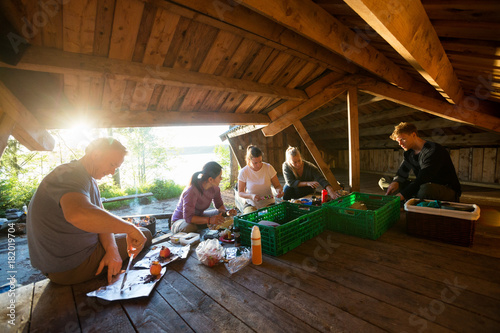 Business People Preparing Meal In Shed At Forest
