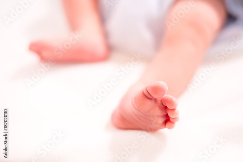 Feet of newborn baby in diaper with copyspace