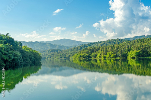 Fototapeta Naklejka Na Ścianę i Meble -  Landscape of the dam and lake on the mountain with tree and forest and the rock with beautiful blue sky and clouds on sunshine day.