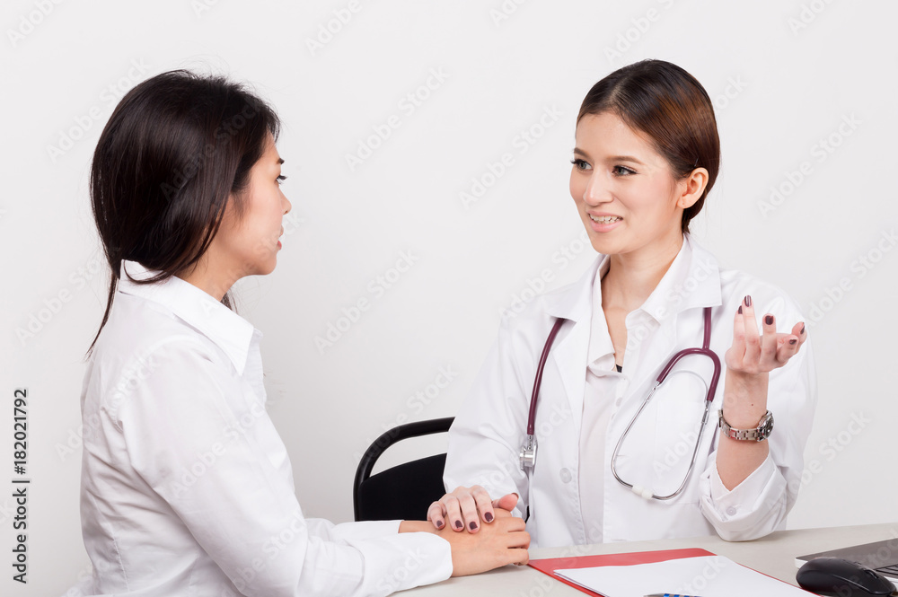 Female Doctor and patient are discussing something in consultant room, in the hospital. Female Doctor and patient are discussing something in consultant room, in the hospital.