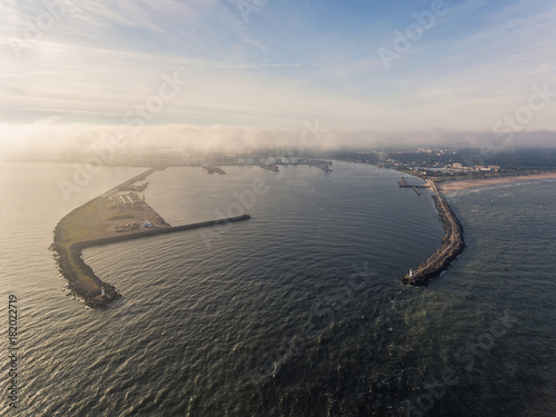 Aerial view over Ventspils pier entrance to the Baltic sea in Latvia, during summer time. photo