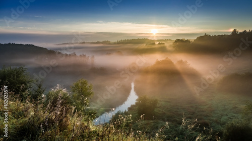 Amazing sunrise at foggy valley in autumn  Europe
