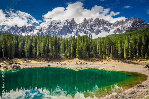 Stunning green mountain Carezza lake in Dolomites, Italy, Europe