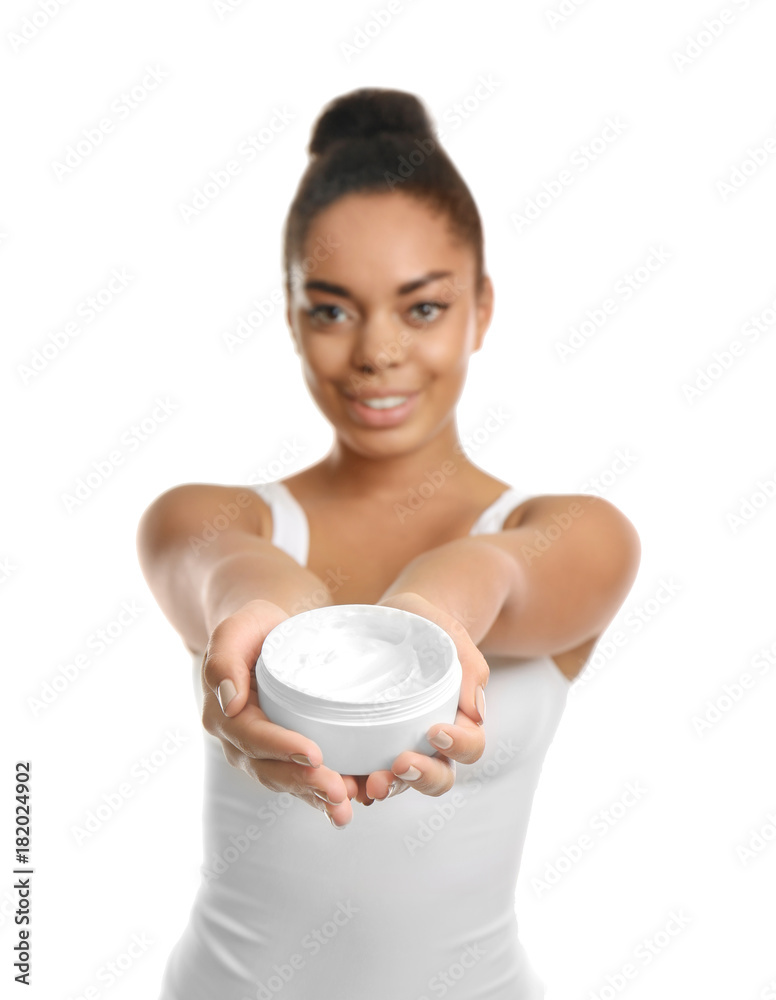 Young African American woman holding jar with cream on white background Young African American woman holding jar with cream on white background