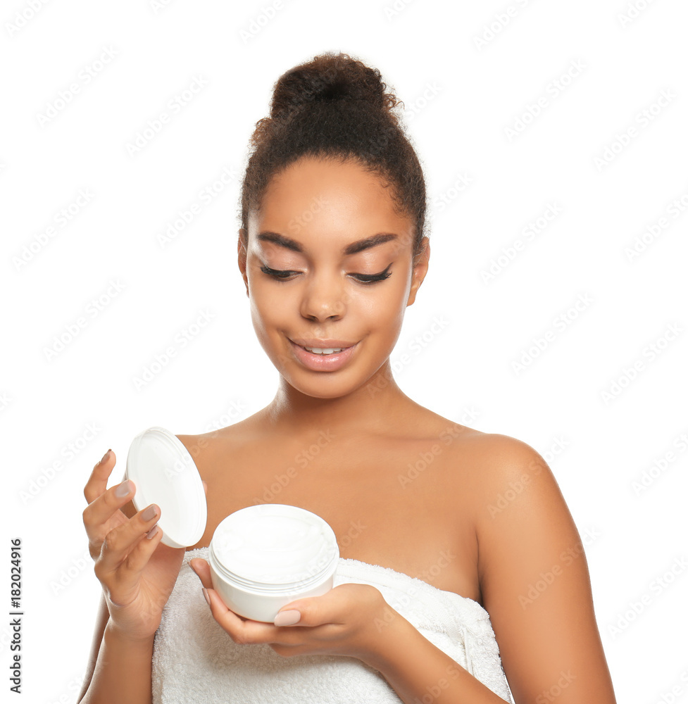 Young African American woman holding jar with cream on white background Young African American woman holding jar with cream on white background
