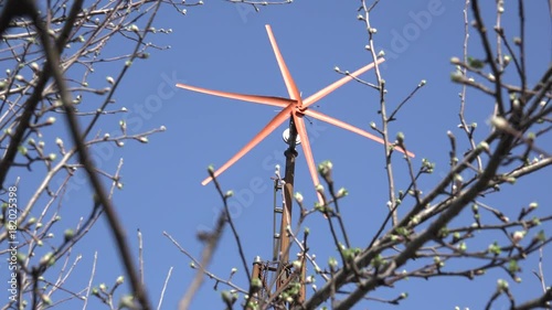 Wind Turbine Start Rotation, Green Energy on Blue. 4K UltraHD video.