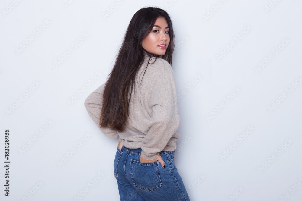 Beautiful and sexy attractive girl in a sexy jeans posing isolated on white  background. Sexy Asian girl with a long hair show her body and butt. Stock  Photo | Adobe Stock