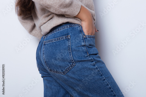 Sexy body of a beautiful girl. Attractive butt in blue jeans. Close up of  sexy butt isolated on white background Stock Photo | Adobe Stock