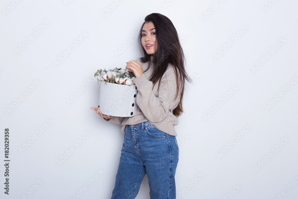Portrait of beautiful Asian girl with holding a composition of New Yer's gift box. Modern gift to parents and friends. Posing of attractive and confident woman Portrait of beautiful Asian girl with holding a composition of New Yer's gift box. Modern gift to parents and friends. Posing of attractive and confident woman
