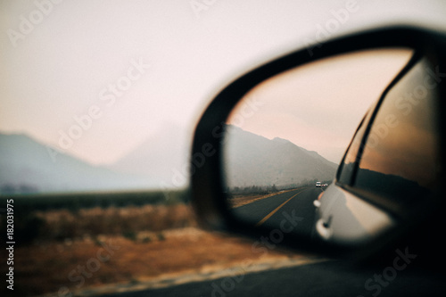 Amazing view of mountains in side mirror of car on roadtrip