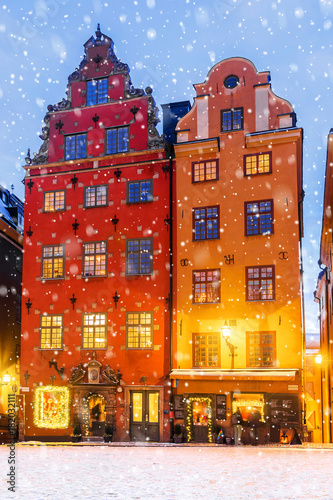 Christmas in Stockholm. Festively decorated houses in the cental square of Stockholm. Nadnisi on griffin boards in English and Swedish with a list of dishes and drinks