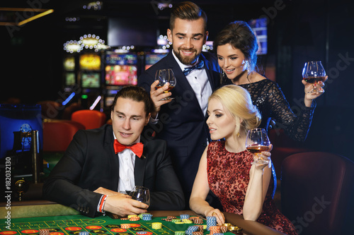 Young and rich people playing roulette in the casino