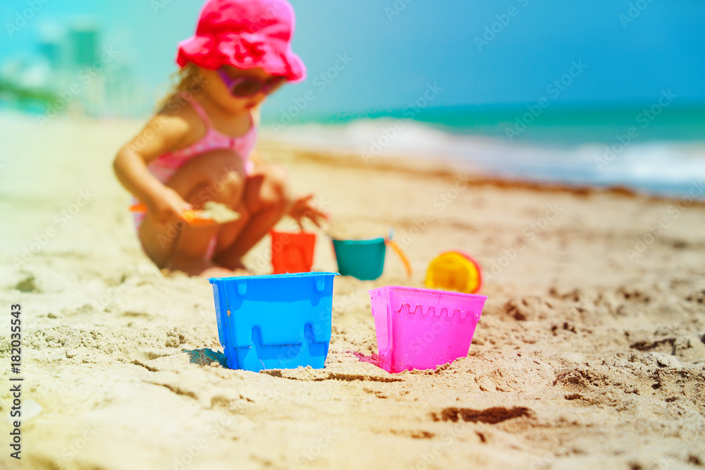 cute little girl play with sand on beach cute little girl play with sand on beach