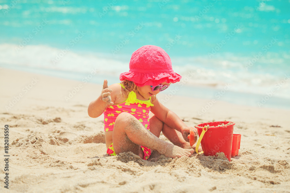 cute little girl play with sand on beach cute little girl play with sand on beach