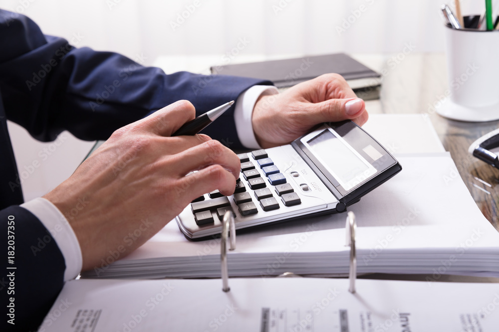 Businessperson Calculating Bill Businessperson Calculating Bill