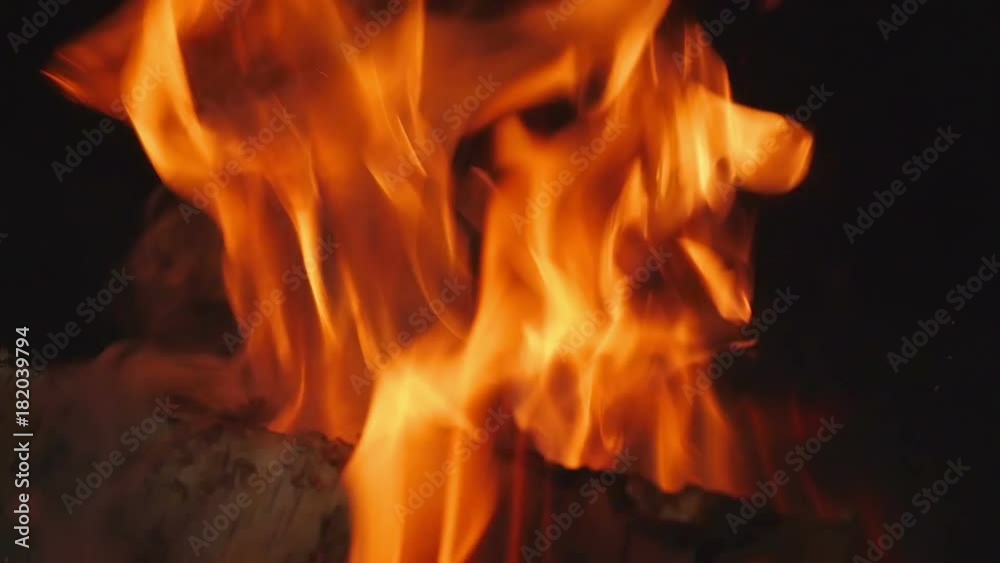 Closeup on beautiful orange flames comming out of indor open fire. Logs burning in dark room in open fireplace in slow motion hd. Closeup on beautiful orange flames comming out of indor open fire. Logs burning in dark room in open fireplace in slow motion hd.