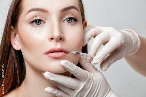 woman getting injection on lips. 