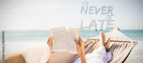 Bild auf Leinwand Composite image of woman reading book on hammock at beach