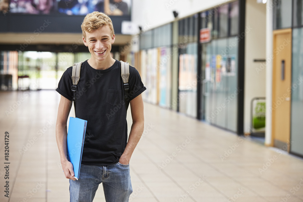 Fototapeta premium Portrait Of Male Student Standing In College Building