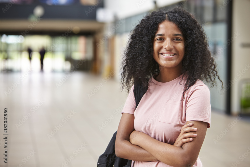 Fototapeta premium Portrait Of Female Student Standing In College Building