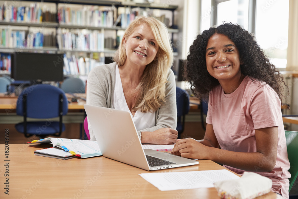 College Student Has Individual Tuition From Teacher In Library College Student Has Individual Tuition From Teacher In Library