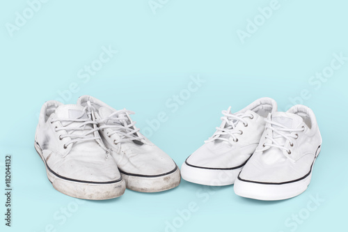 Pair of clean and dirty sneakers on turquoise background