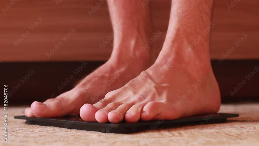 Barefoot on scales with tape centimeter Barefoot on scales with tape centimeter