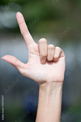 Female pointing finger sign up to the sky. © Suphansa