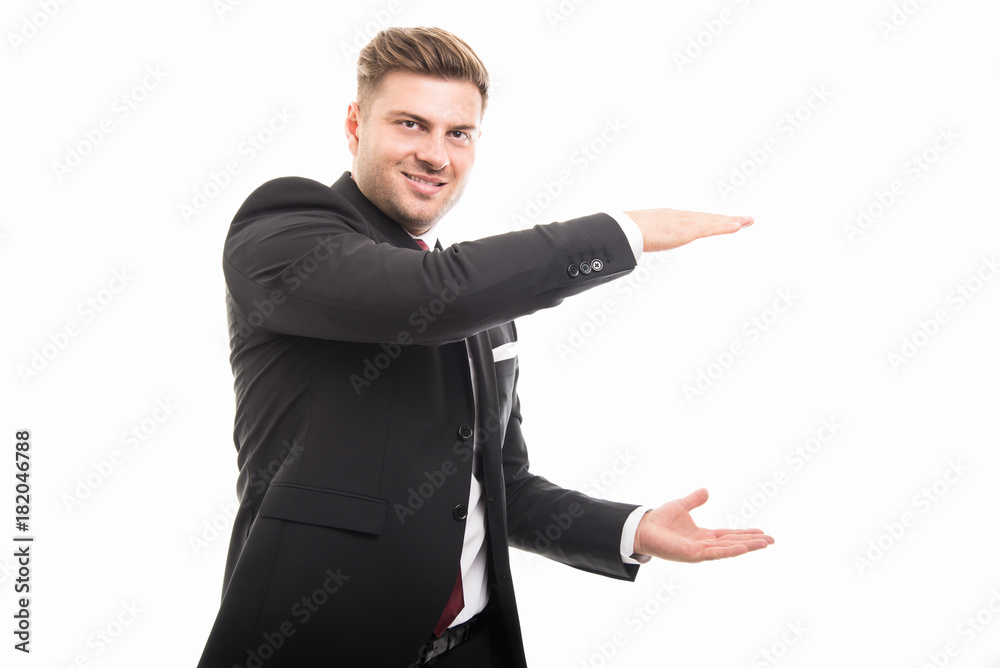 Handsome business man holding copyspace area Handsome business man holding copyspace area
