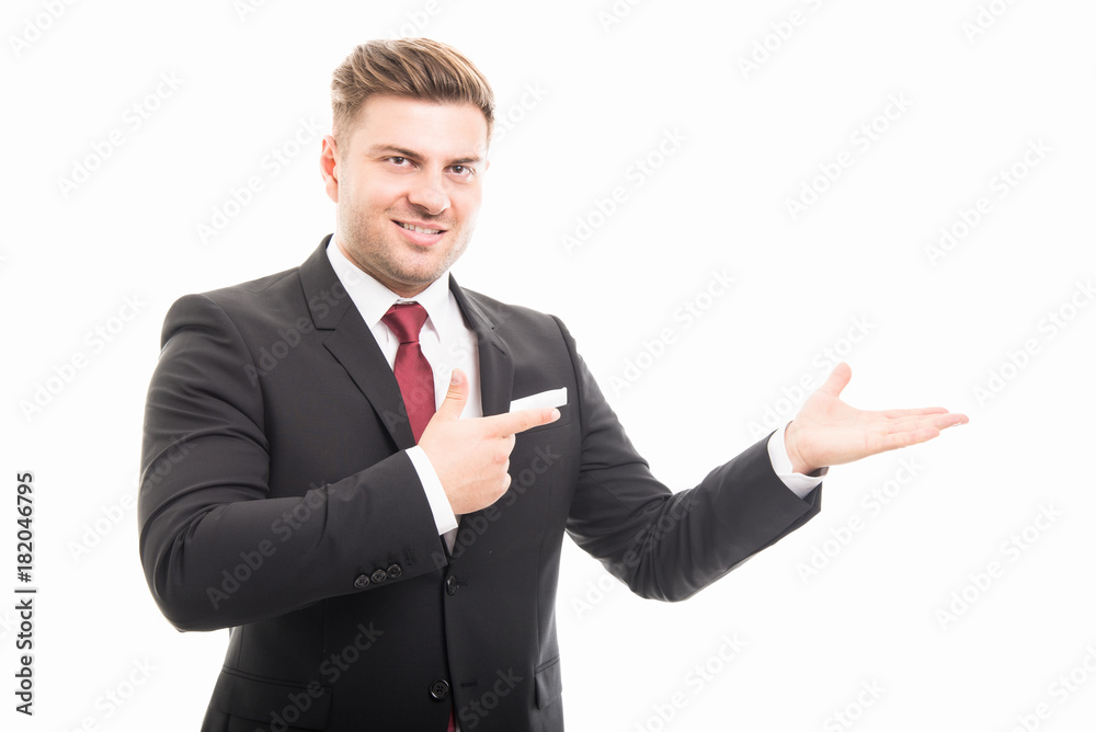 Handsome business man pointing copyspace area Handsome business man pointing copyspace area
