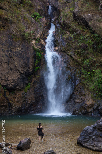 Woman standing on waterfall