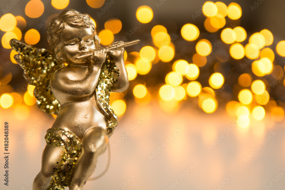 Fototapeta Golden christmas cherub figure on shiny white and gold background