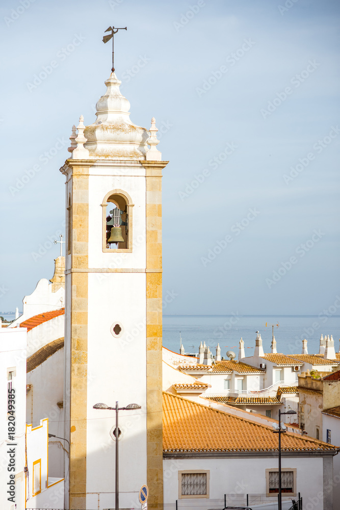 Cityscape view on the old town with beautiful white houses and bell tower in Albufeira city on the south of Portugal
