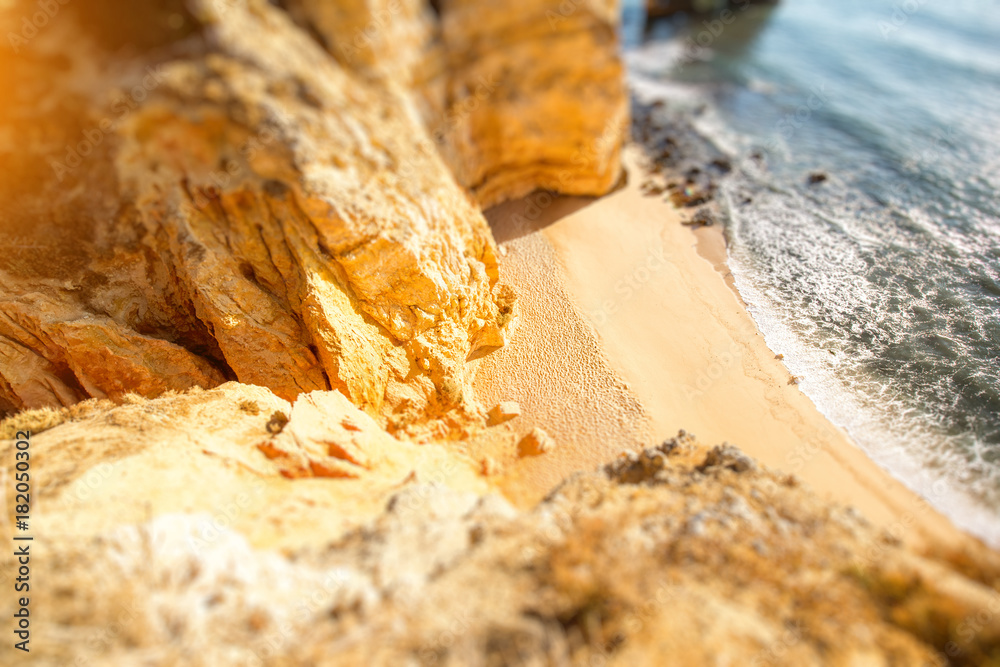 Top view on the beautiful sandy beach on the Ponta da Piedade near the Lagos city in Portugal. Tilt-shift image technic