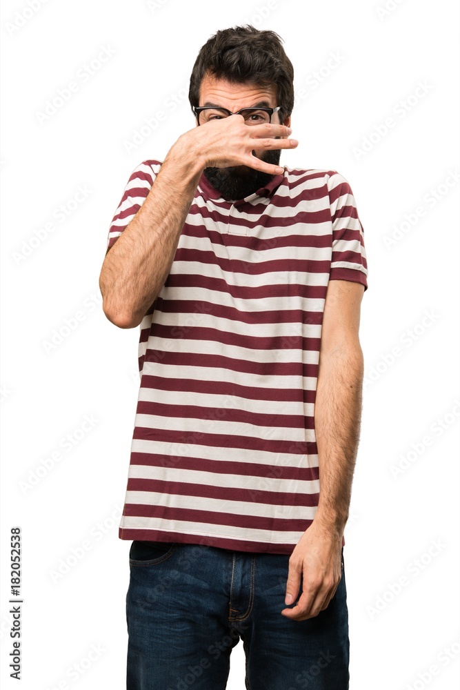 Man with glasses making smelling bad gesture