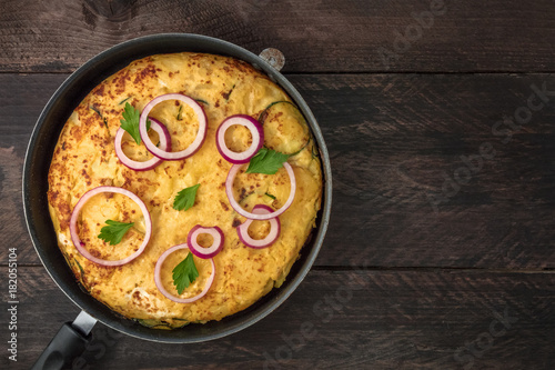Spanish tortilla in tortillera with copy space, top view