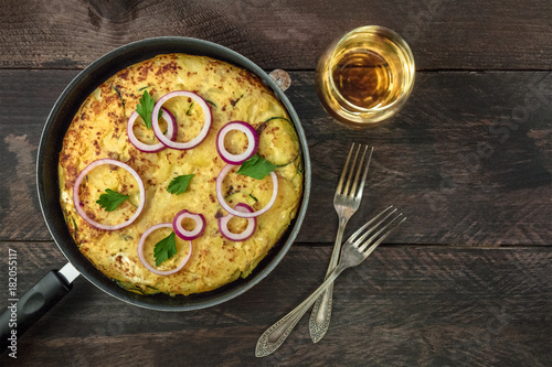 Spanish tortilla in tortillera with white wine and copyspace