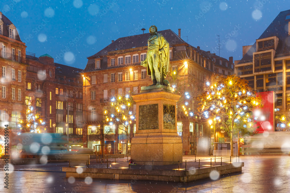 Statue of Jean-Baptiste Kleber on the Christmas Place Kleber decorated and illuminated in Old Town of Strasbourg at night, Alsace, France