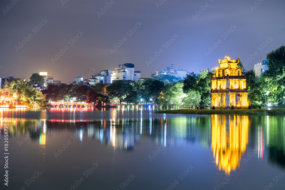 Gold Turtle tower with The Huc red bridge in Hoan Kiem lake at night