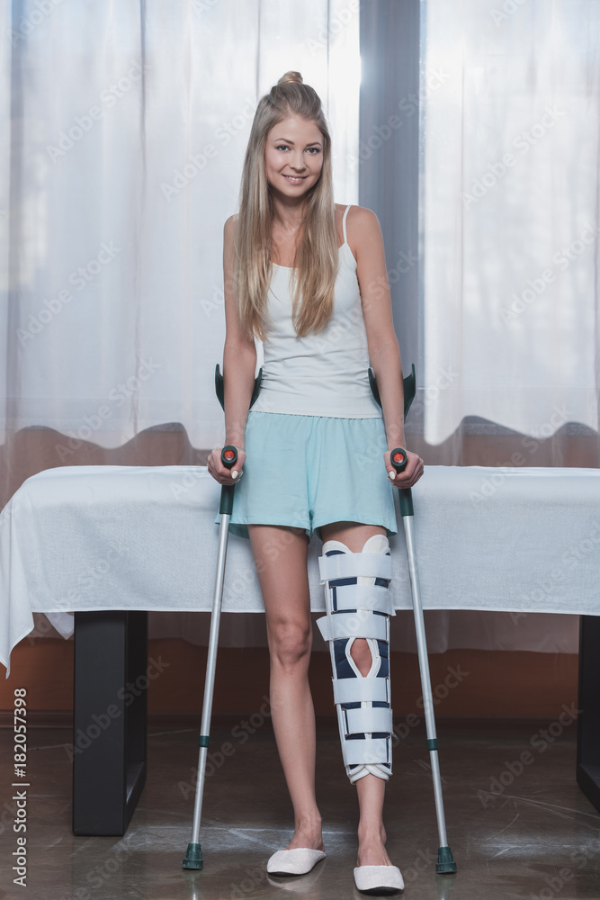 girl with crutches and leg brace Stock Photo | Adobe Stock