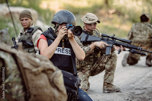 Photojournalist documenting war conflict. in the mountain.