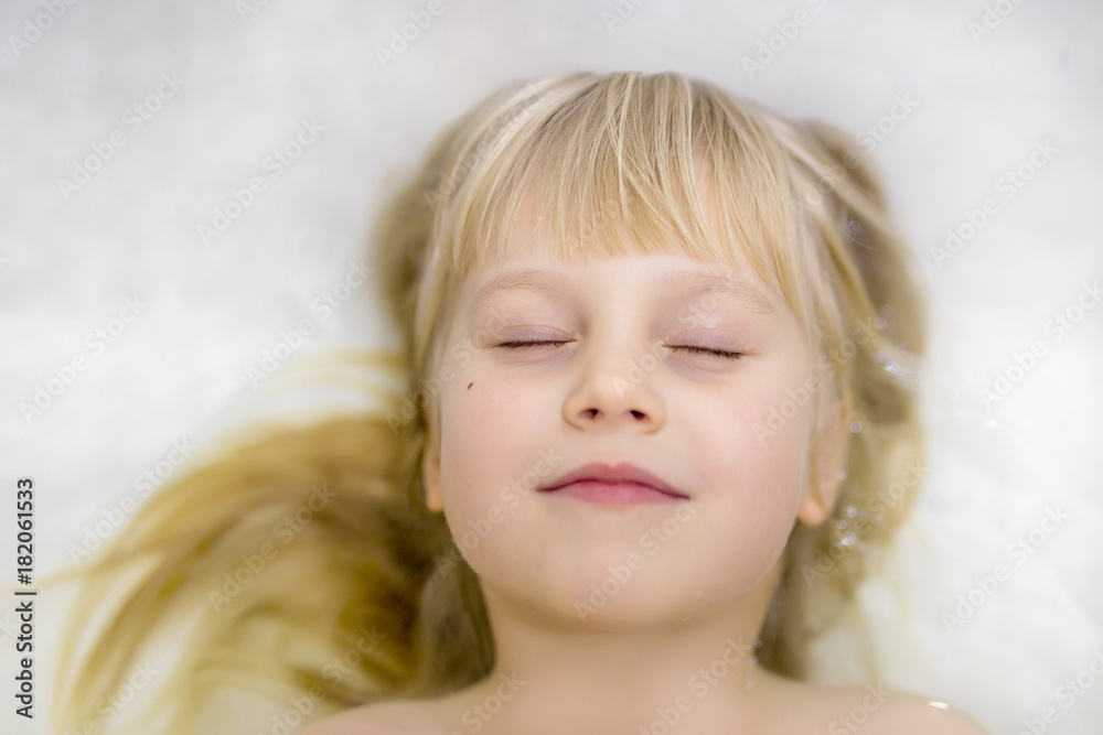 Portrait off cute little blond caucasian kid girl smiling and having fun while bathing Portrait off cute little blond caucasian kid girl smiling and having fun while bathing
