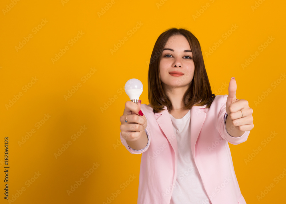 Young cute woman with electric bulb, studio Young cute woman with electric bulb, studio