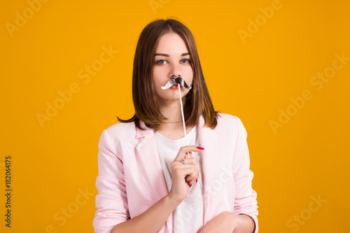 Young cute girl with moustache, studio 