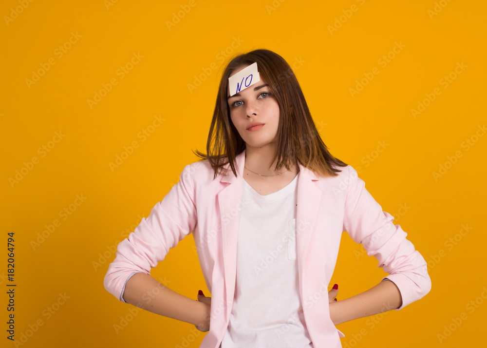 Young cute girl, sticker on a head, studio Young cute girl, sticker on a head, studio